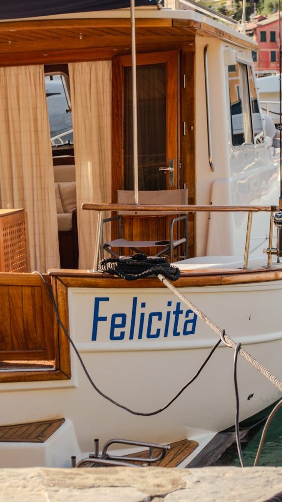 Elegant yacht named Felicita docked in scenic Portofino, Italy, showcasing nautical charm.